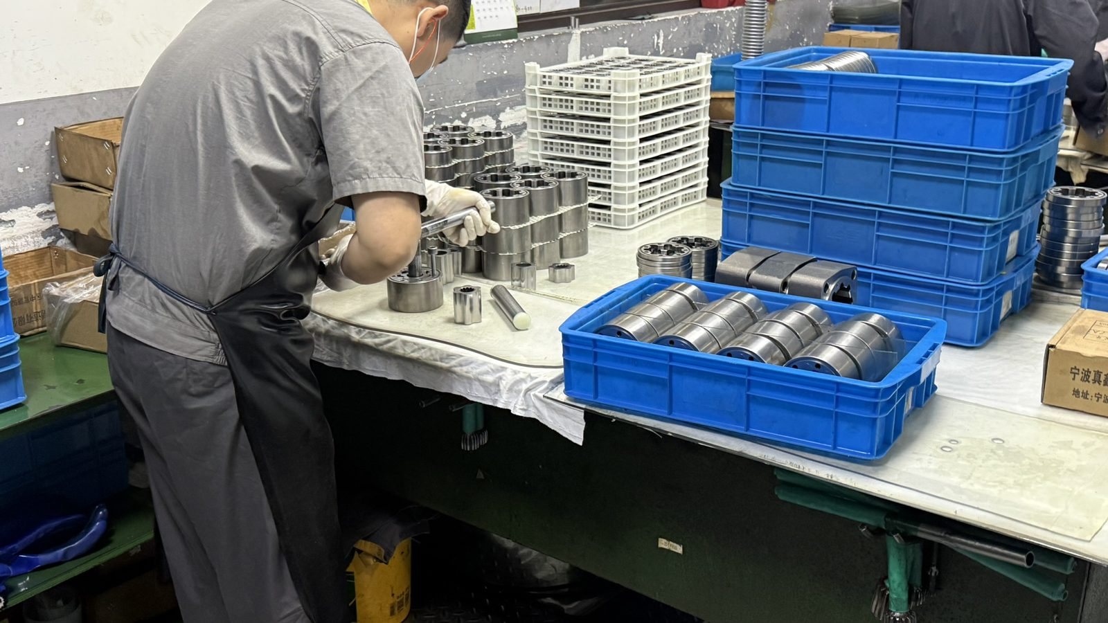 Technician preparing hydraulic motor parts for assembly