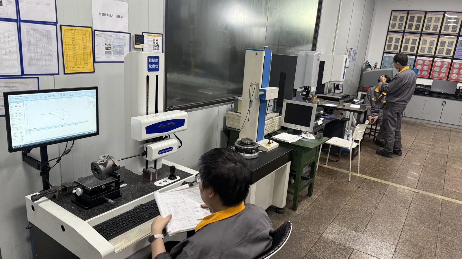 Metrology lab with operator measuring hydraulic motor parts