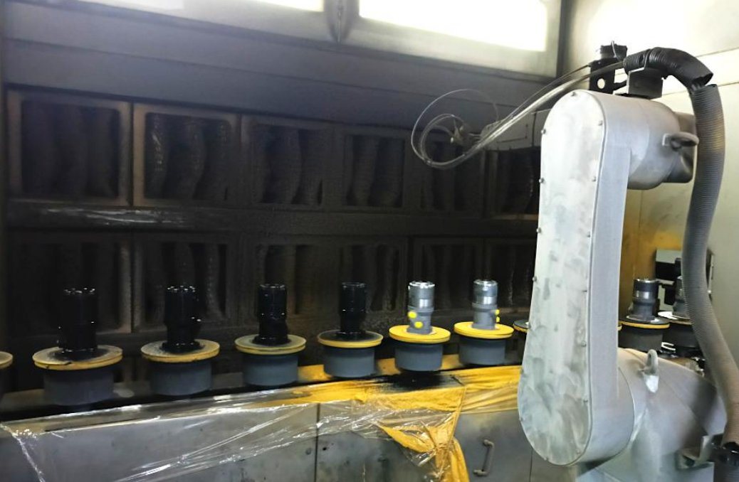 Robot painting hydraulic motors in the paint booth