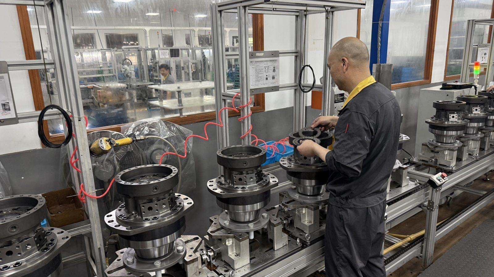 Skilled technician assembling a hydraulic motor on the assembly line