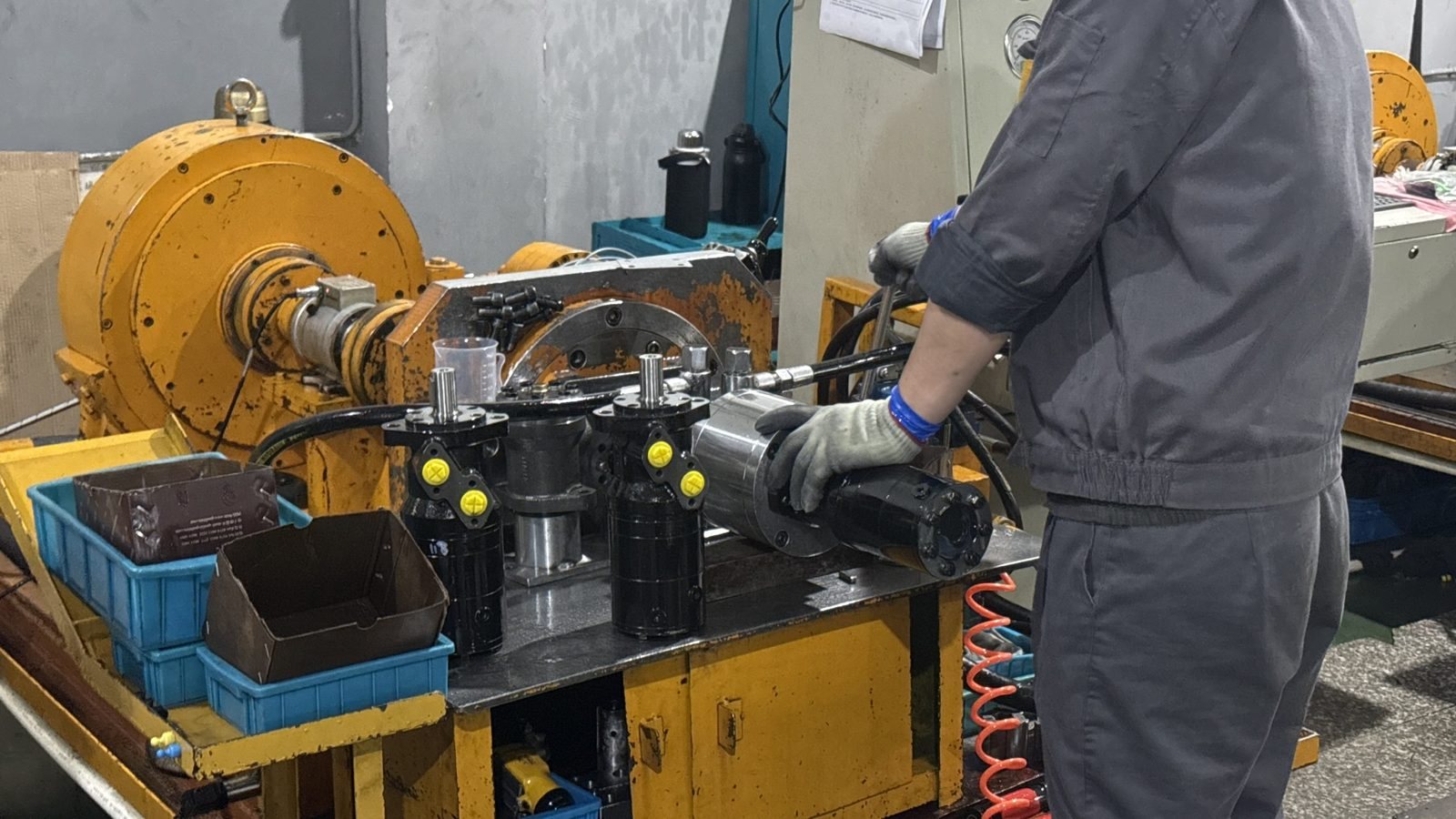 Technician assembling orbital motors at a workbench