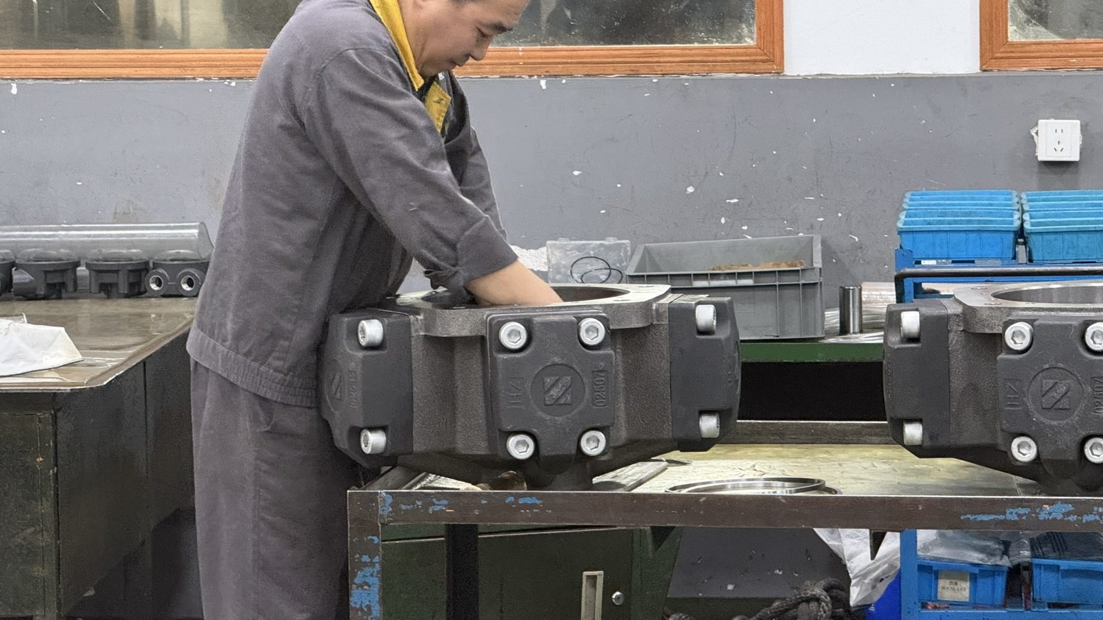 Technician performing a final hands-on check of a hydraulic motor
